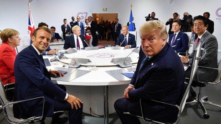 Donald Trump sits with the other G7 summit attendees at a round table.