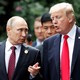 U.S. President Donald Trump and Russia's President Vladimir Putin talk during the family photo session at the APEC Summit in Danang, Vietnam November 11, 2017.