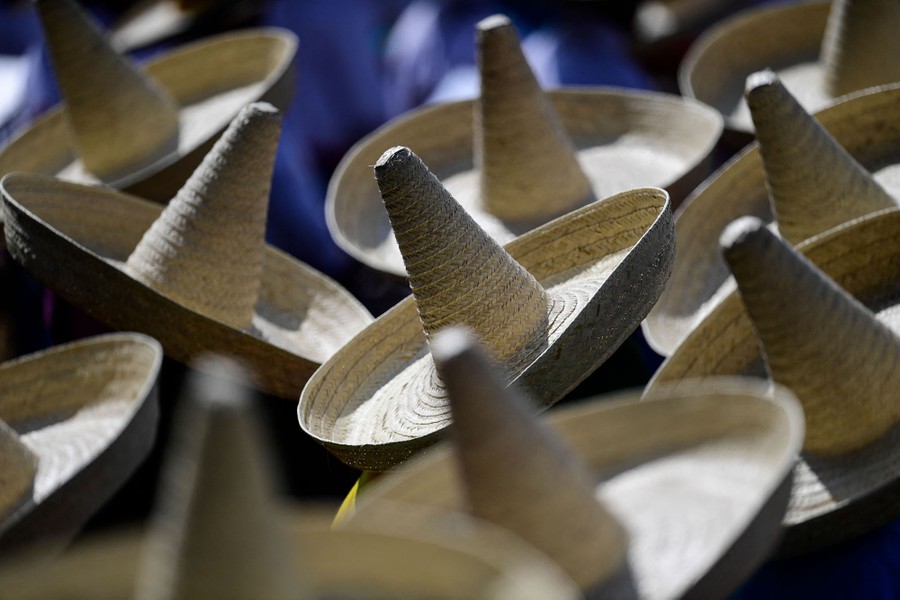 A view from above of about a dozen people wearing sombreros.