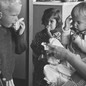 Black-and-white photo of children blowing their noses