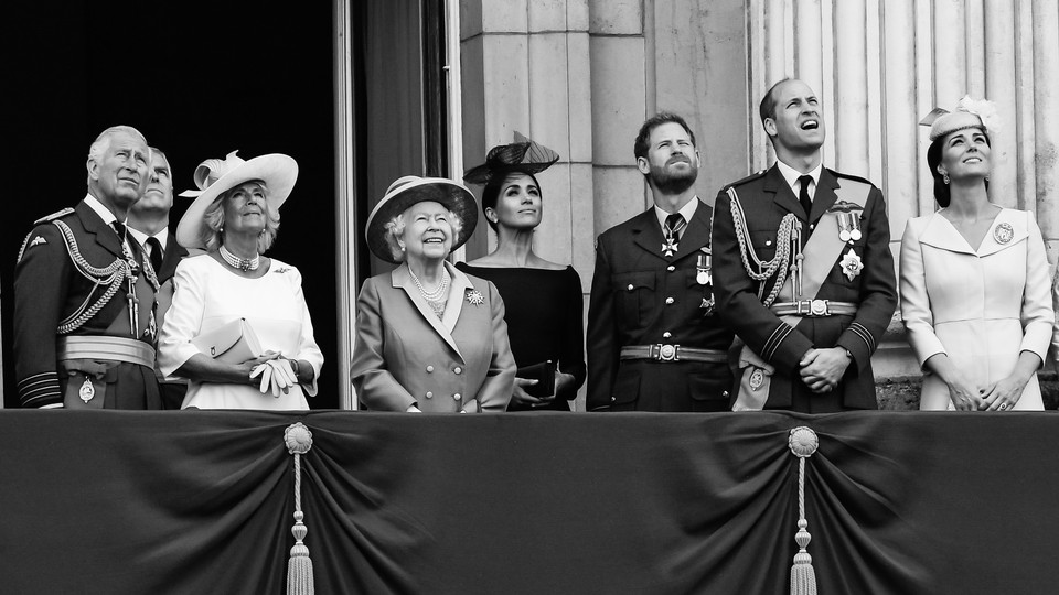 Prince Charles, the Prince of Wales; Camilla, the Duchess of Cornwall; Prince Andrew, the Duke of York; Queen Elizabeth ll; Meghan, the Duchess of Sussex; Prince Harry, the Duke of Sussex; Prince William, the Duke of Cambridge; and Catherine, the Duchess of Cambridge, stand on the balcony of Buckingham Palace.