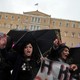 Suspended Finance Ministry janitors protest outside the Greek Parliament in 2013.
