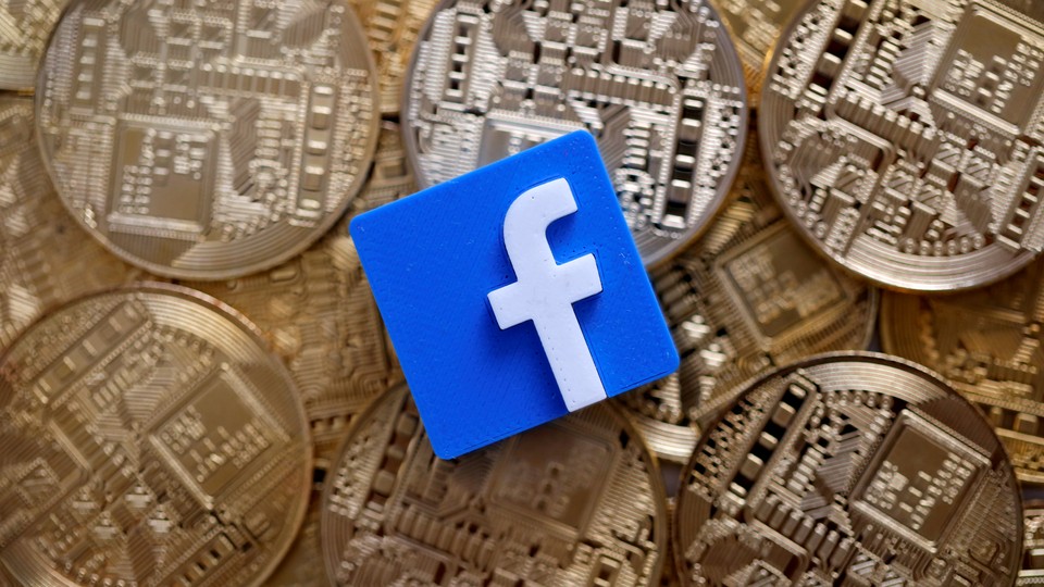 A 3-D printed Facebook logo is seen on representations of the bitcoin virtual currency in an illustration picture
