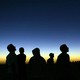 Libyan youths watch the solar eclipse in the desert tourist camp in Galo.
