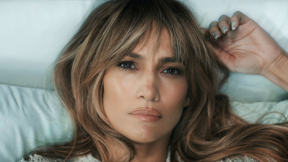 Close-up shot of Jennifer Lopez lying down and looking serious