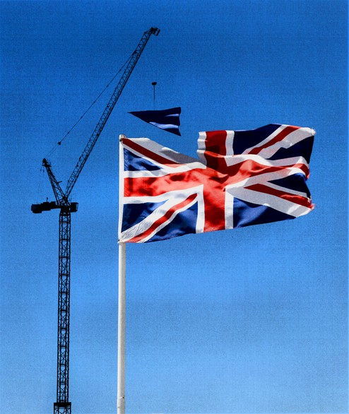 A stylized image of a crane appearing to add a part to the United Kingdom flag.