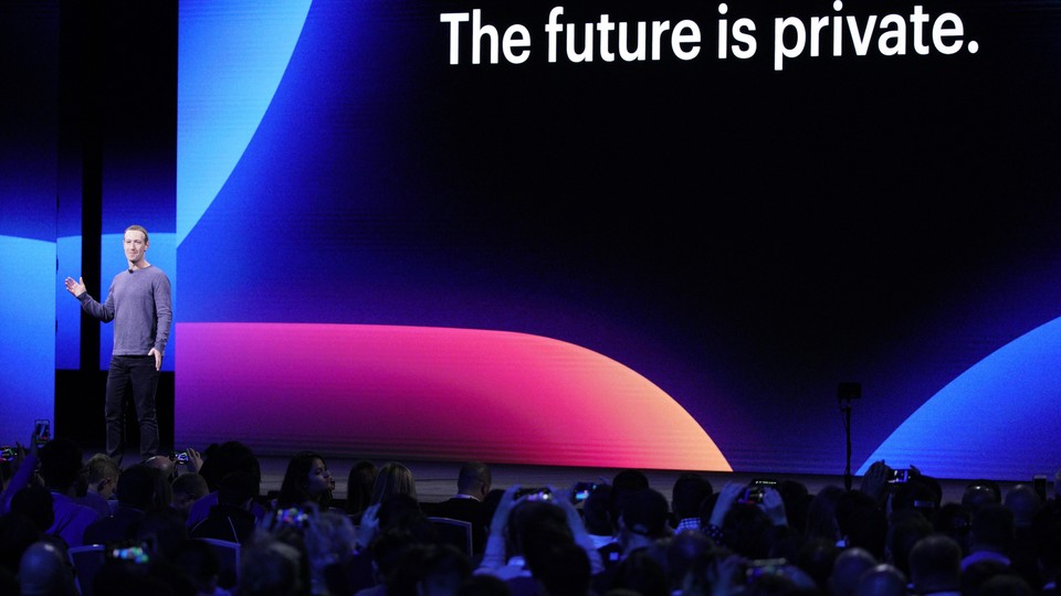 Mark Zuckerberg speaks onstage in front of a sign that says "The future is private."