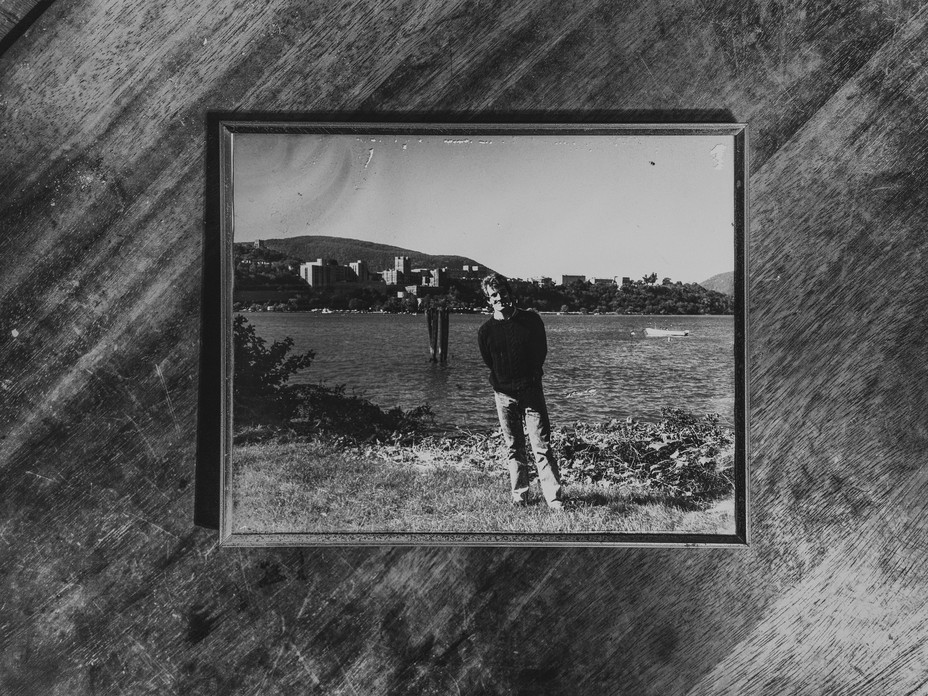 photograph of a man on a wood table