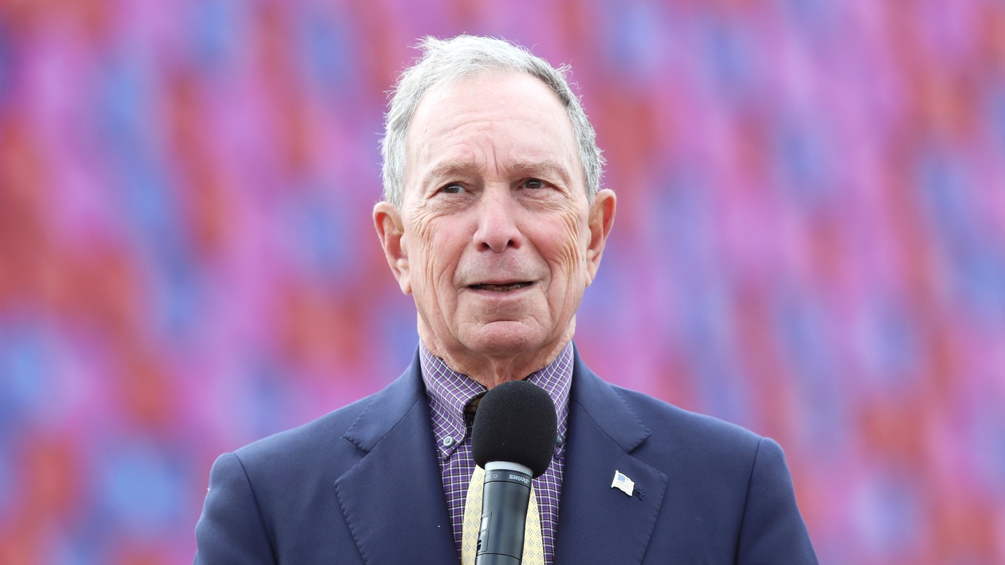 Mike Bloomberg holding a microphone