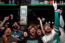 Football fans watch the Super Bowl.