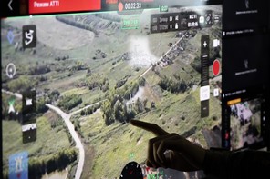Video footage from drones on a screen