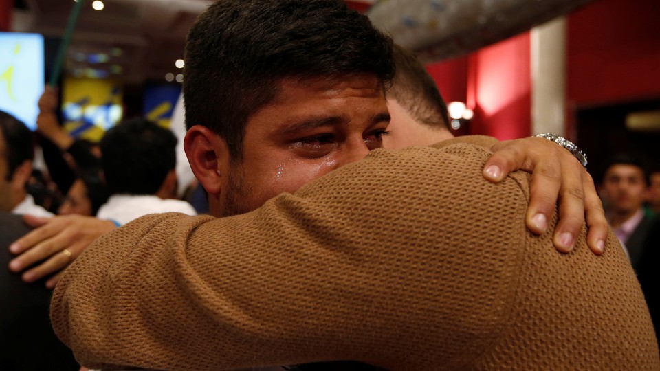 Two men hug and cry after the nation votes "no" on the recent FARC referendum.