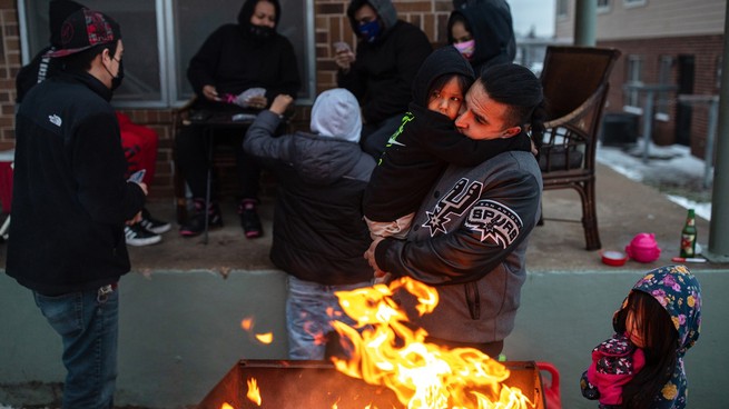 Texas families huddling around a fire
