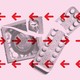 A picture of a ripped condom and birth control package set against a pink background.