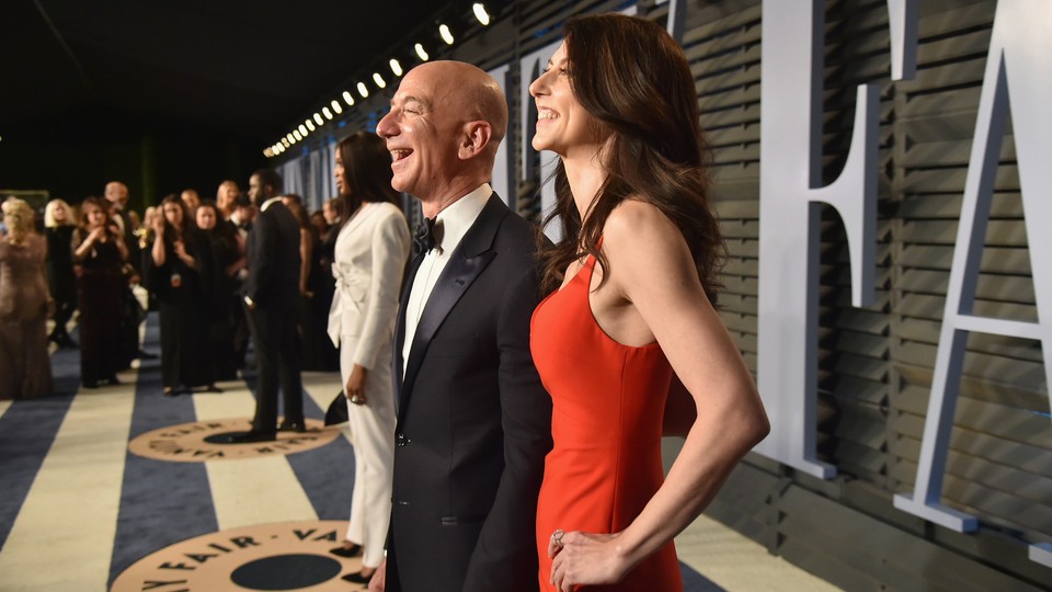Jeff Bezos and his wife MacKenzie pose for pictures