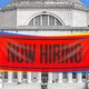 Columbia's library with a cartoonishly large and bright NOW HIRING sign hanging over it