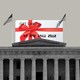 A giant gift card on top of a building