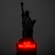 The Statue of Liberty, with a "No Vacancy" neon sign on the pedestal