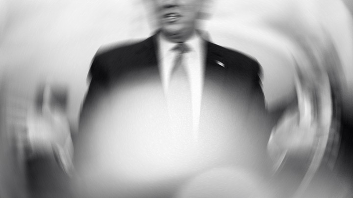 A shaken, overexposed black-and-white photo of Donald Trump speaking