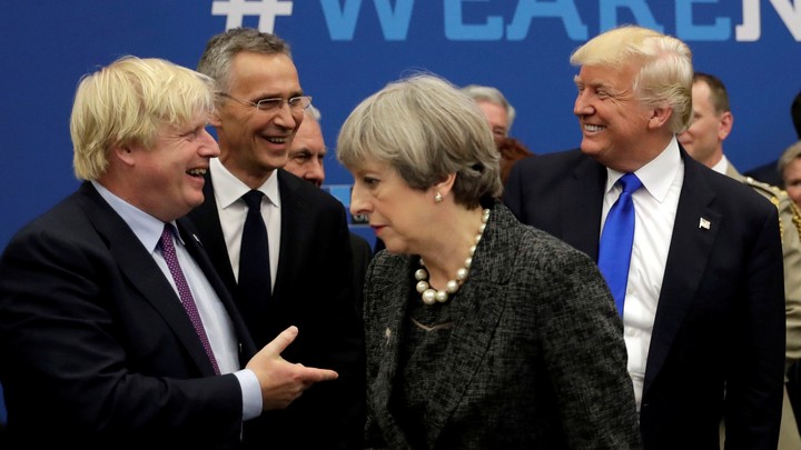 Boris Johnson greets Donald Trump; Theresa May faces away.