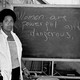 Audre Lorde in front of a blackboard that reads: "Women are powerful and dangerous."