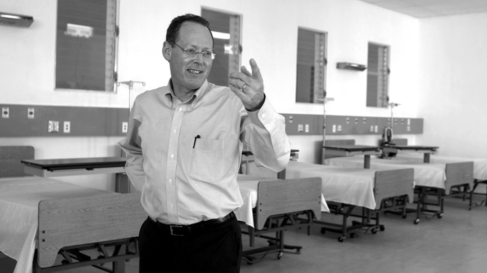 The humanitarian Paul Farmer standing up and smiling