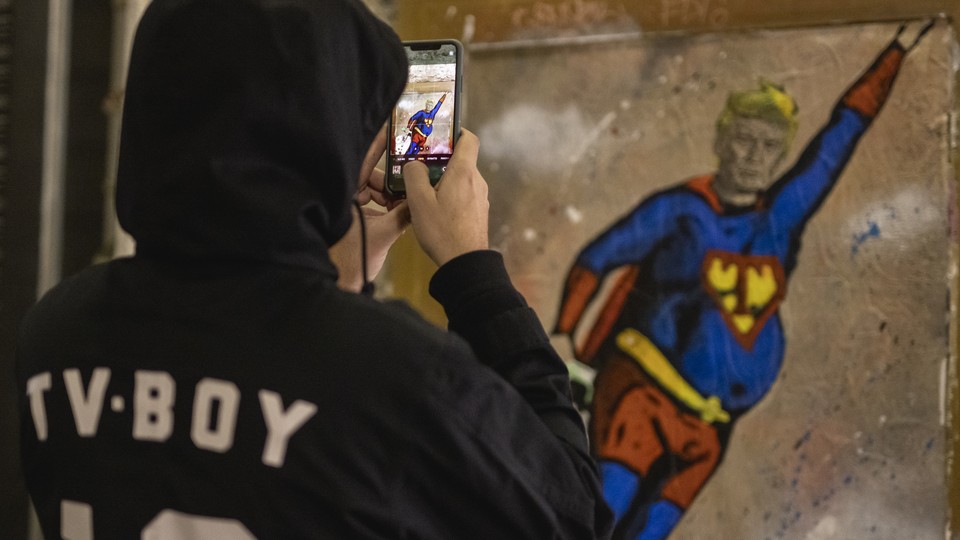 Artist takes photo of image of Donald Trump in Superman costume