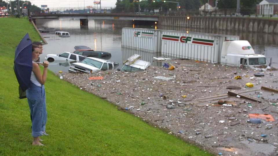 Stranded motorists look over a flooded I-45 North near downtown Houston after tropical storm Allison, in 2001.
