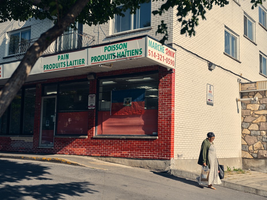 a woman walks in front of a store