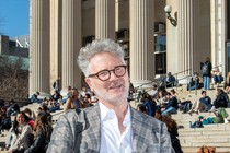 Adam Tooze stands on Columbia University's Campus outdoors.