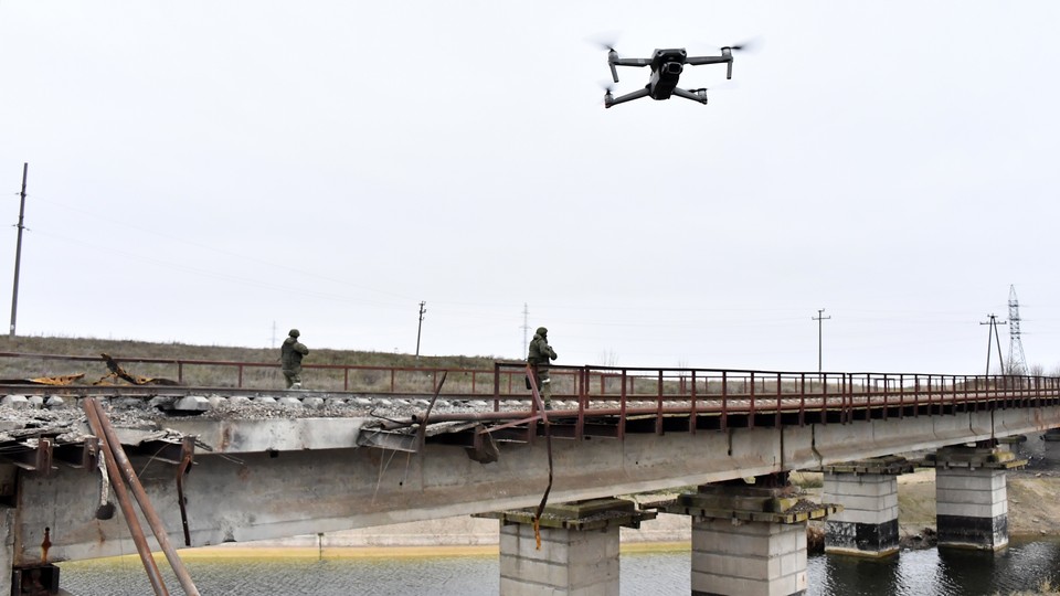 A drone hovers over railway tracks in a Russian-occupied location in Ukraine's Kherson region.