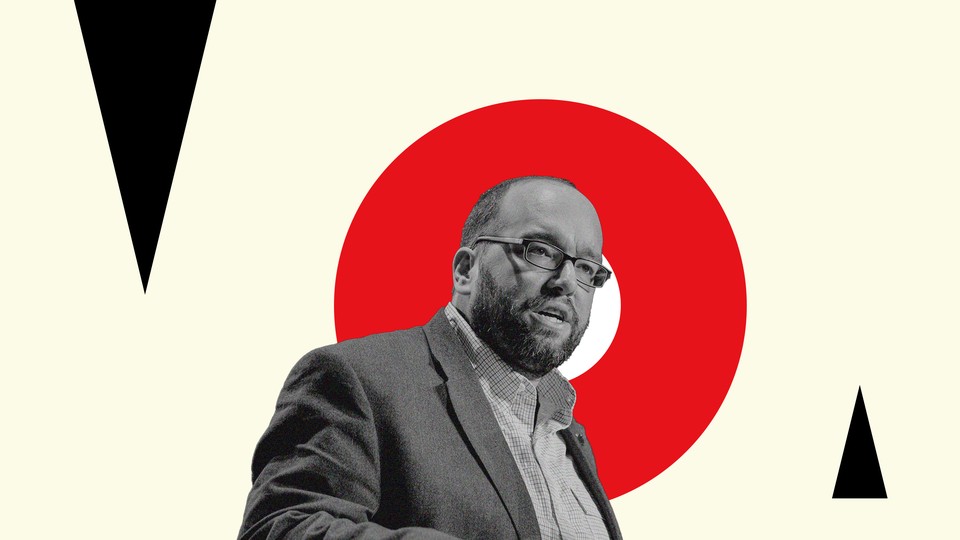 Dan Darling in black and white on a background of colorful graphic imagery.