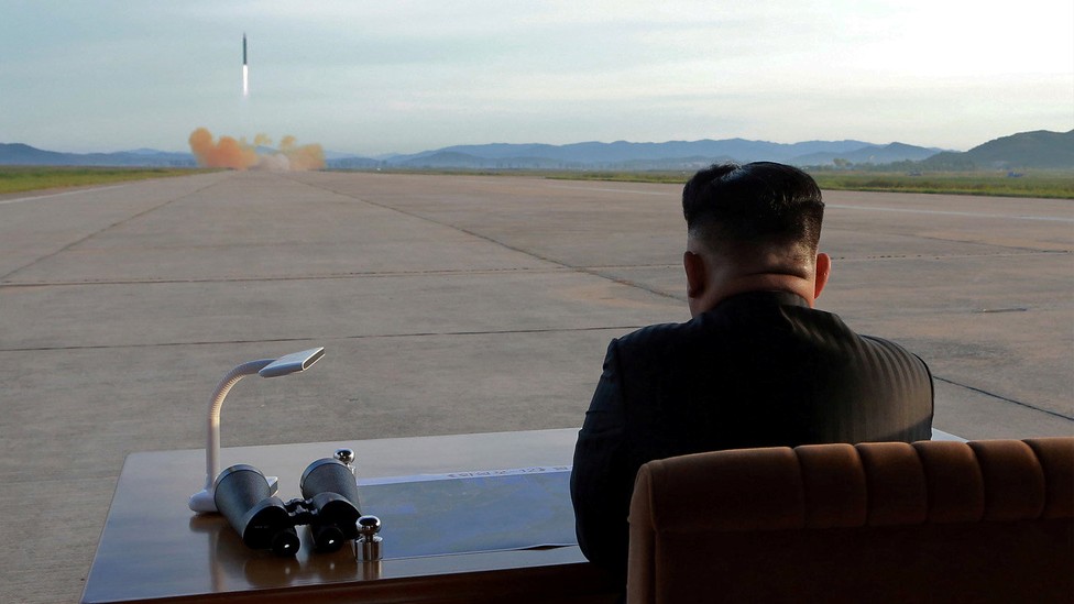 Kim Jong Un watches the launch of a Hwasong-12 missile.