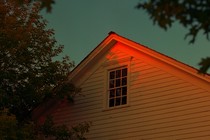 A yellow house at sunset