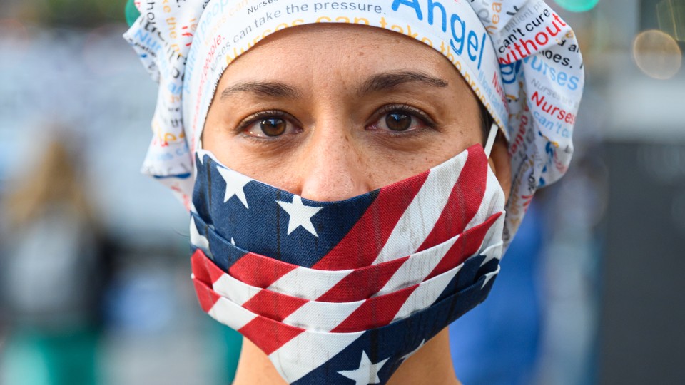 A health worker wearing an American-flag face mask