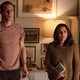 Tobias Menzies and Julia Louis-Dreyfus standing in front of a living-room couch with appalled looks on their faces