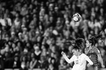 Photo of a U.S. and Portuguese player contesting a soccer ball