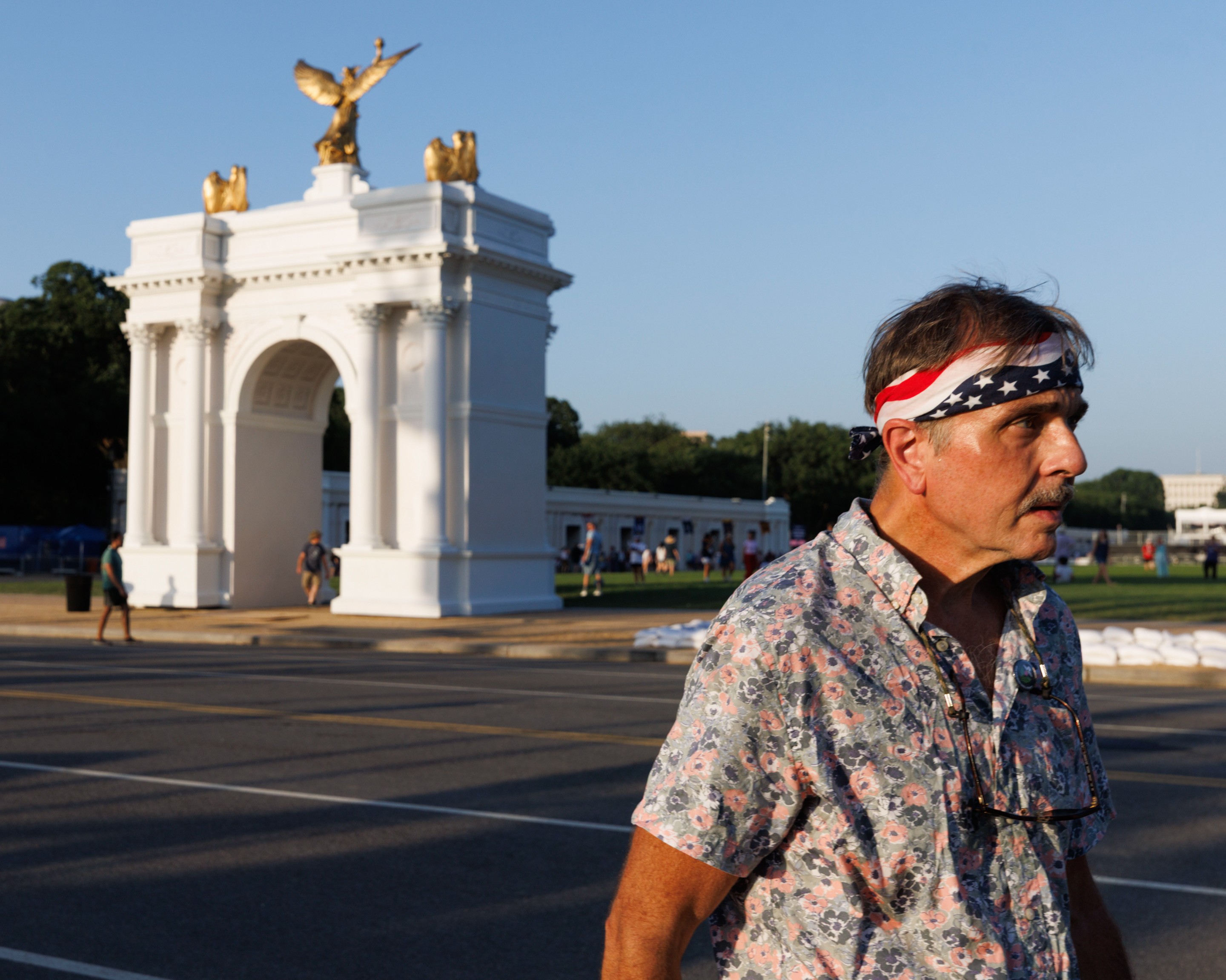 a man walks past an arch