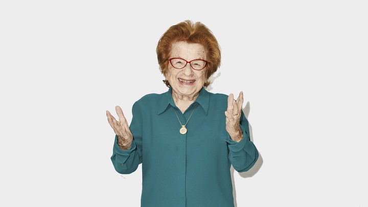 A photo of Dr. Ruth holding out her hands and smiling