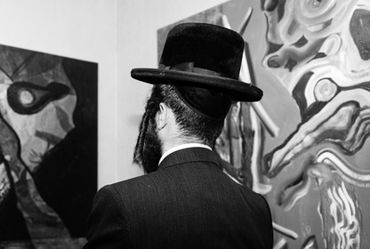 A man admiring art in a gallery