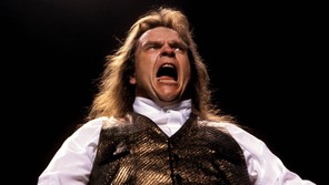 Meat Loaf singing in a shiny waistcoat
