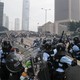 Riot police prepare to throw tear gas at protesters in Hong Kong.