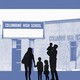 A silhouette of a family standing in front of Columbine