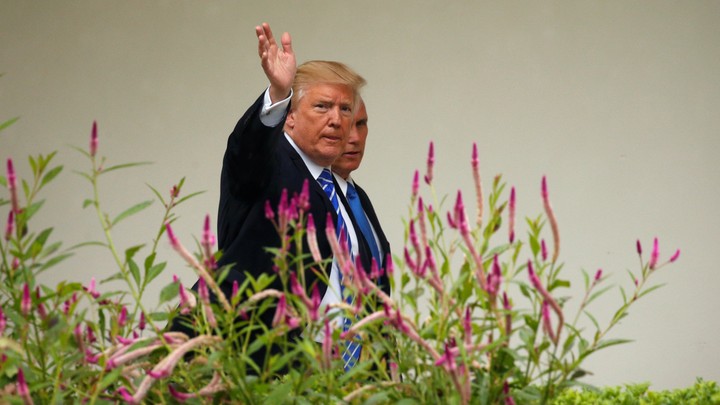 Donald Trump waves to photographers.