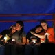 Young women comfort each other at a vigil in El Paso.