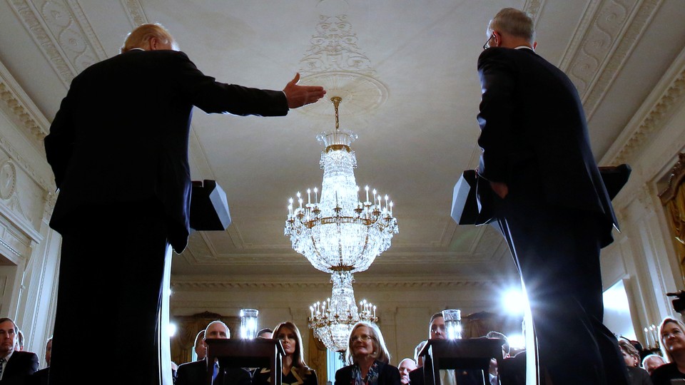 President Donald Trump gestures toward the former Australian prime minister inside the White House