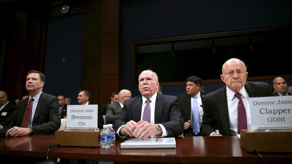 James Comey, John Brennan, and James Clapper at a House Intelligence Committee hearing in 2015