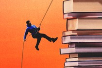 A person rappelling down a stack of books