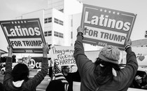Two Trump supporters hold placards saying "Latinos for Trump" during a rally in Los Angeles.