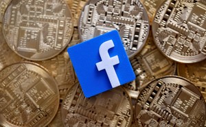 A 3-D printed Facebook logo is seen on representations of the bitcoin virtual currency in an illustration picture